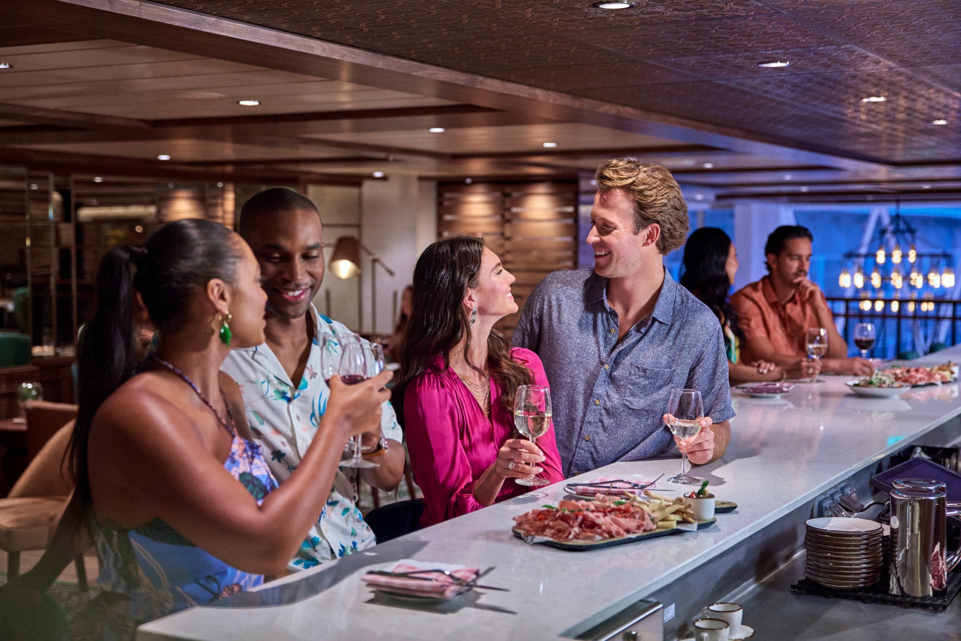 Friends enjoying wine and small plates at Giovanni's Wine Bar aboard Utopia of the Seas