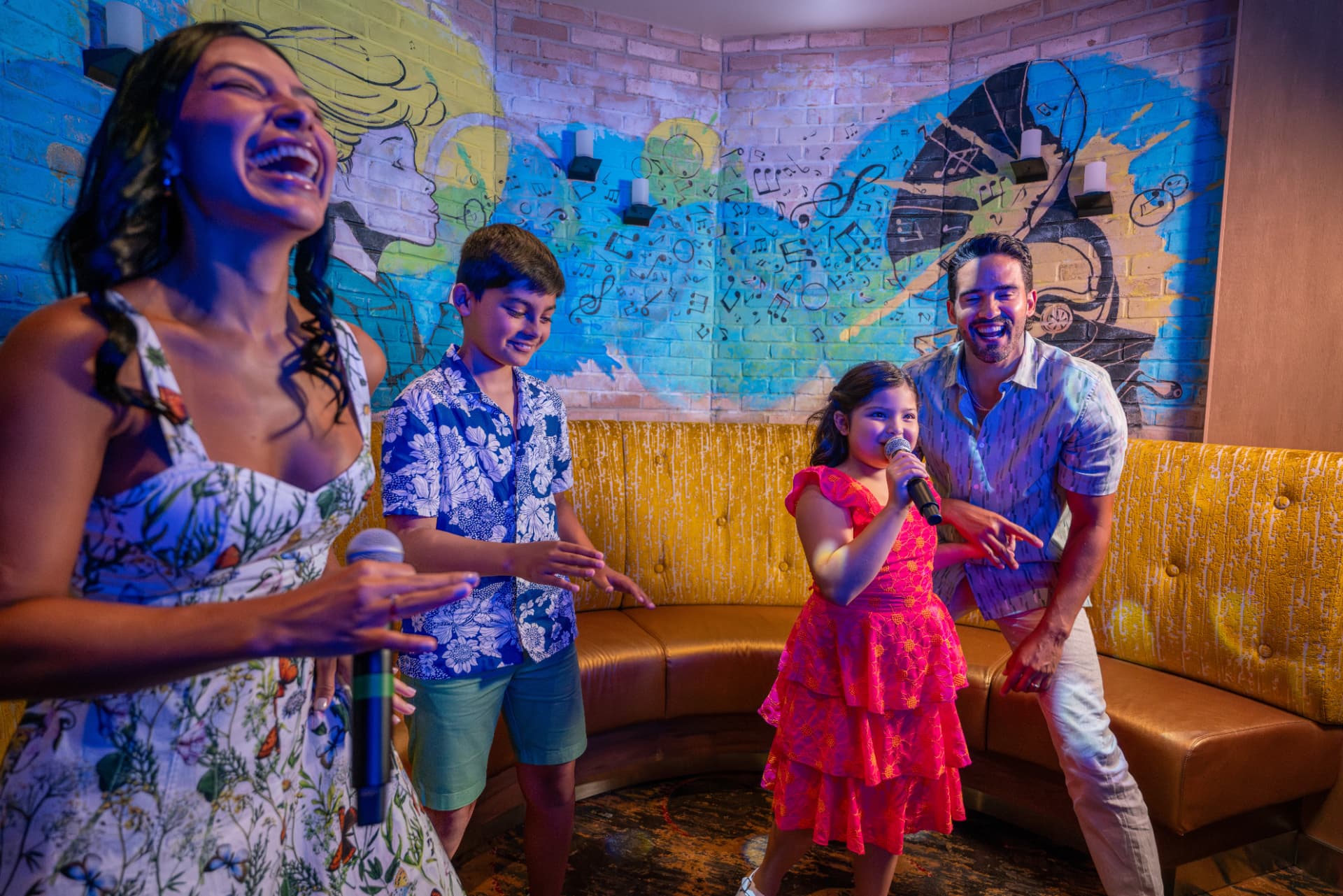 Family singing together at Spotlight Karaoke aboard Utopia of the Seas
