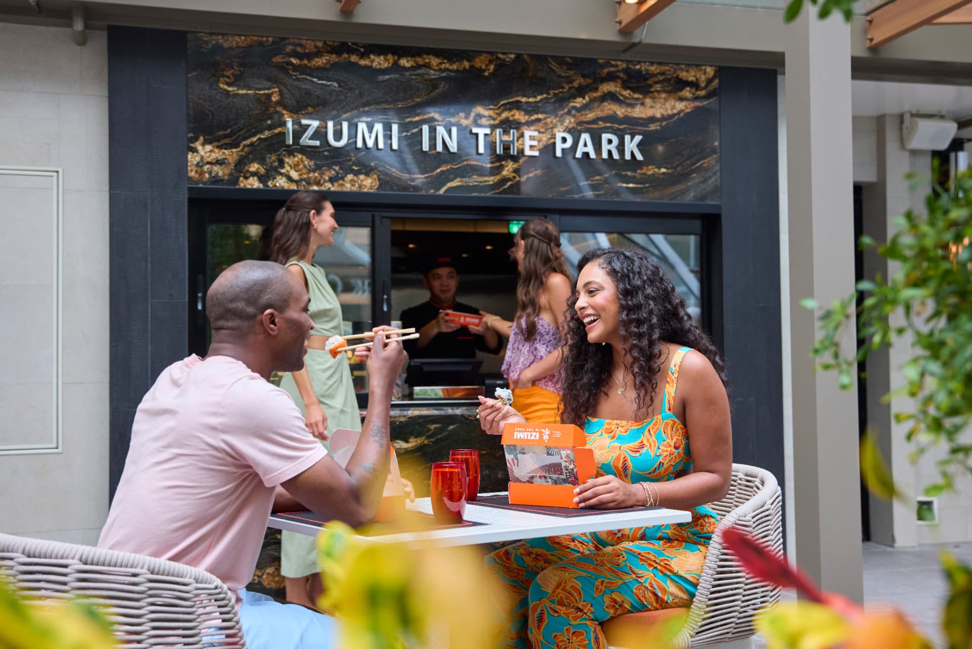 Guests enjoying food outside Izumi in the Park aboard Utopia of the Seas