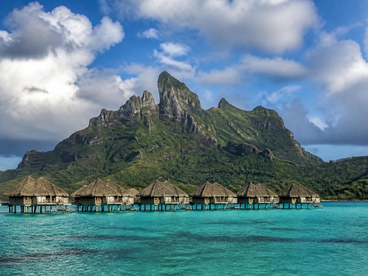 Mount Otemanu rising above the turquoise lagoon and overwater bungalows of Bora Bora, French Polynesia